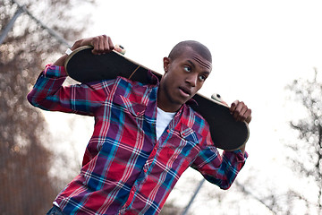 Image showing Skateboarding Guy Taking a Break