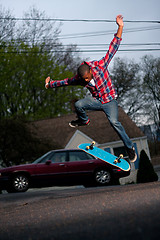 Image showing Skateboarder Man Doing a Kick Flip