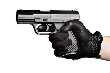 Image showing Hand Pointing a Black Handgun 