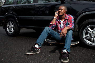 Image showing Skateboarding Guy Talking on the Phone