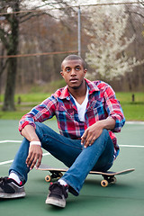 Image showing Skateboarding Guy Taking a Rest