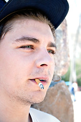 Image showing Young Man Smoking a Cigarette