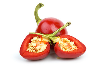 Image showing Whole round red hot pepper and two halves