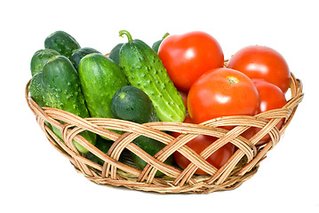 Image showing Wicker basket with some tomatoes and cucumbers