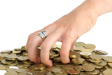 Image showing Hand grabbing coins from the pile