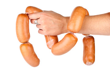 Image showing Hand holding sausages chain isolated on the white background