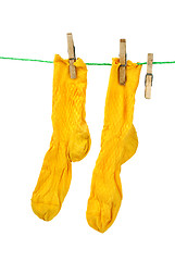 Image showing Pair of yellow socks hanging on the rope