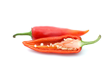 Image showing Whole and half red hot peppers