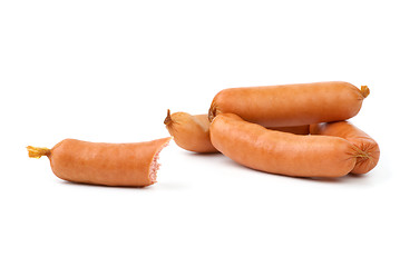 Image showing Few whole and one half-eaten sausages