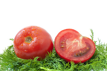 Image showing Ripe red tomato and half ower some dill