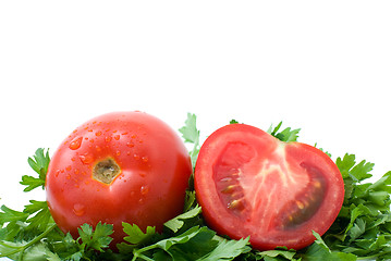 Image showing Whole and half of tomato over some parsley