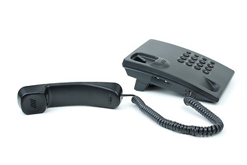 Image showing Black office phone with handset near