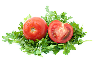 Image showing Ripe red tomato and half with some parsley