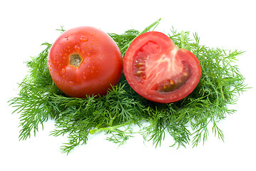 Image showing Whole and half of tomato over some dill