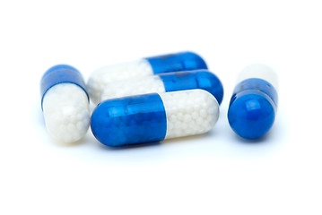 Image showing Four white-blue pills