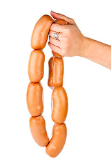 Image showing Hand holding sausages chain
