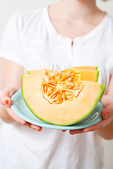 Image showing Woman with cantaloupe melon