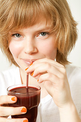 Image showing Woman drinking blueberry smoothie