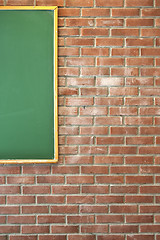 Image showing Brick wall with green blackboard