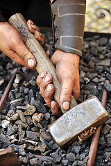 Image showing Detail of dirty hands holding hammer - blacksmith