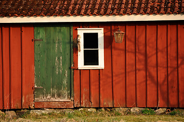 Image showing Red house with green door