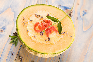 Image showing fresh melon soup with parma ham and lavender flower