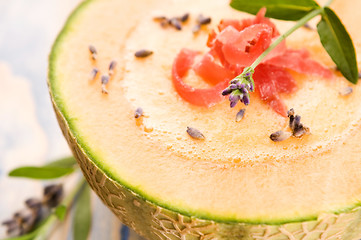 Image showing fresh melon soup with parma ham and lavender flower