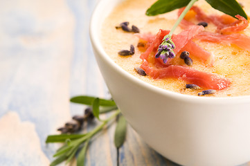 Image showing fresh melon soup with parma ham and lavender flower