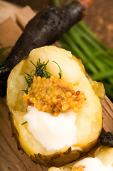 Image showing Baked potato with sour cream, grain Dijon mustard and herbs