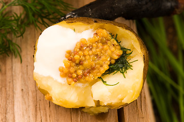 Image showing Baked potato with sour cream, grain Dijon mustard and herbs