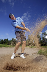 Image showing golfer shooting a golf ball