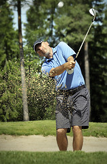 Image showing golfer shooting a golf ball