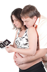 Image showing Couple holding a sonogram of their child