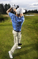 Image showing golfer shooting a golf ball 