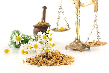 Image showing chamomile flowers with mortar and scales