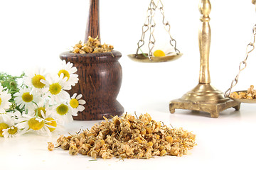 Image showing chamomile flowers with mortar and scales