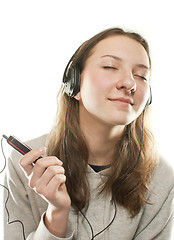 Image showing Teen girl listening music isolated on white