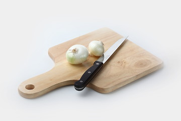 Image showing Cutting onion on the wooden board