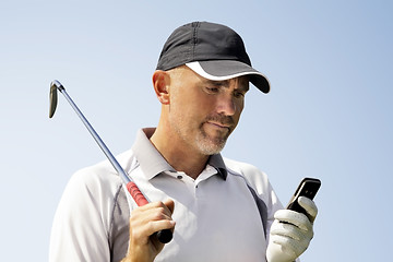 Image showing Golfer using mobile phone