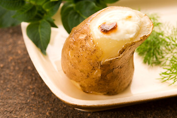 Image showing Baked potato with sour cream and fresh dill