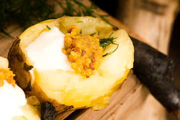 Image showing Baked potato with sour cream, grain Dijon mustard and herbs