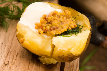 Image showing Baked potato with sour cream, grain Dijon mustard and herbs