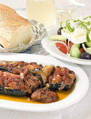 Image showing Greek stuffed eggplant and Greek salad crusty bread wine