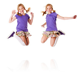 Image showing Happy identical twins jumping and laughing