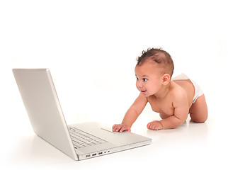 Image showing Sweet Cute Baby Boy Playing With a Laptop Computer on White