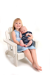 Image showing Preschooler Holding Her Newborn Baby Brother on White Background