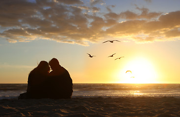 Image showing Happy Couple Watching the Sunset in Love on the Beach