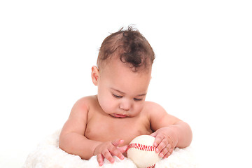 Image showing Sweet Infant Boy Gazing at a Baseball