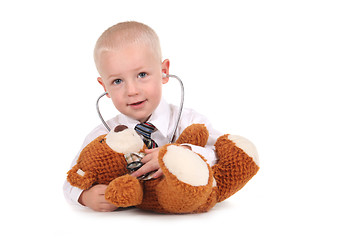 Image showing Sweet Little Boy Caring for His Teddy Bear