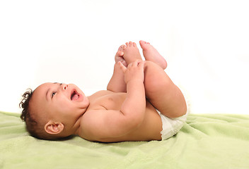 Image showing Infant Happily Shrieking in Laughter While Lying Down